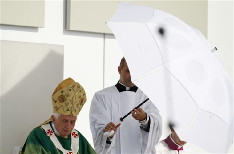 Pope Benedict XVI is shielded against the sun during an open-air mass in Freiburg, Germany, Sunday, Sept.25, the last day of a four-day-visit to his homeland Germany.